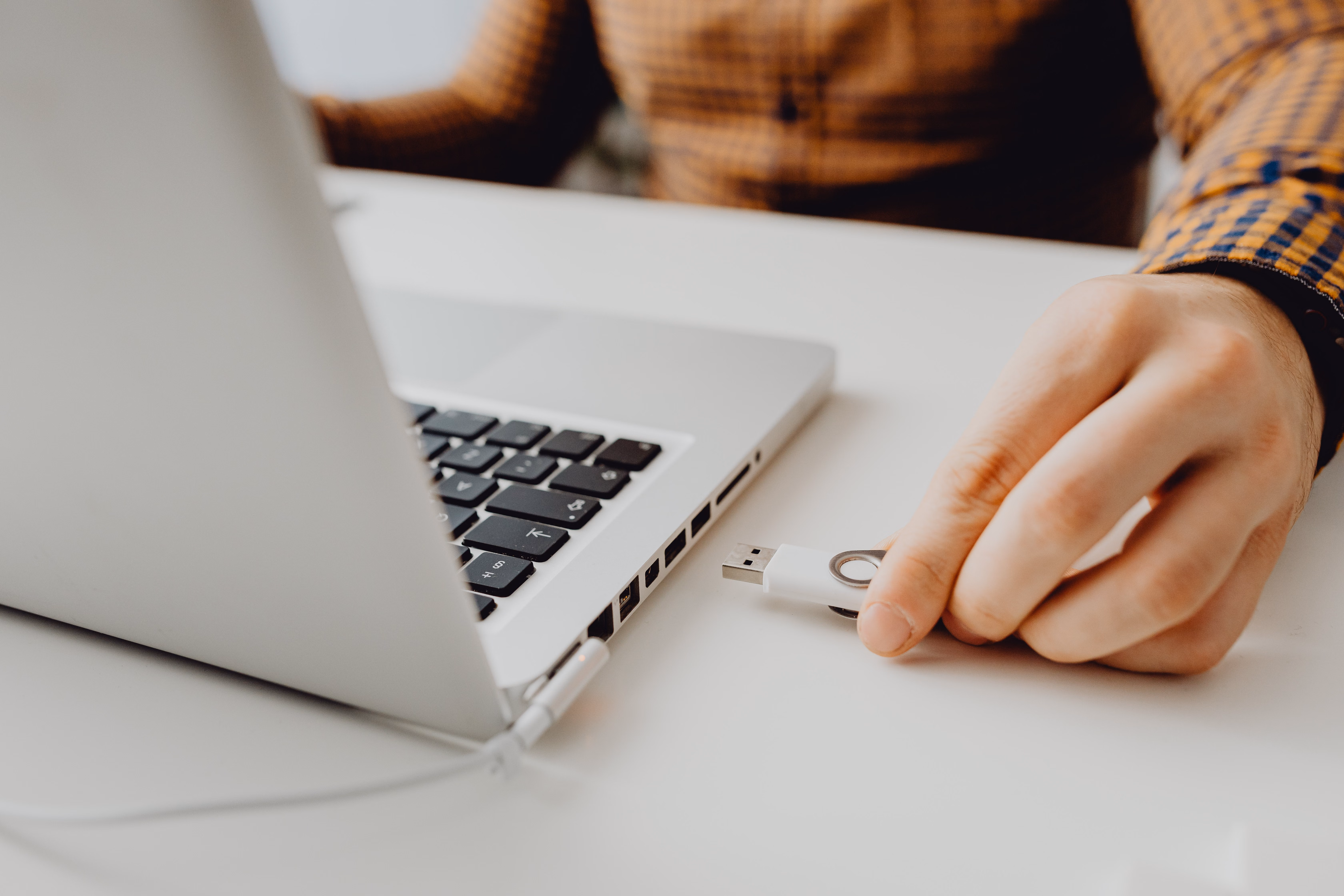 checking laptop ports before buying Close-up of a laptop's side showing USB-C, USB-A, HDMI ports, with a screwdriver nearby